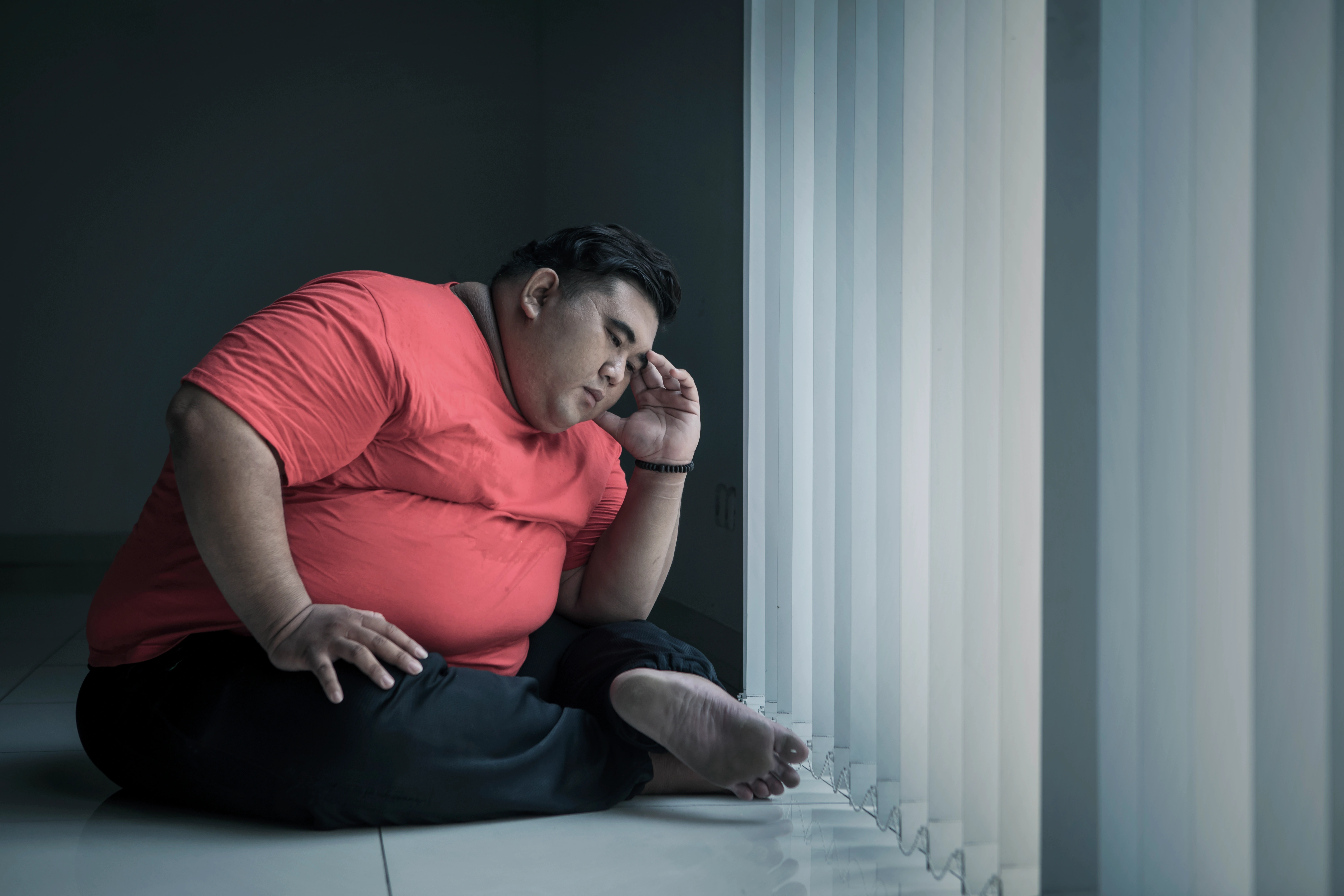 Obese man looking stressed